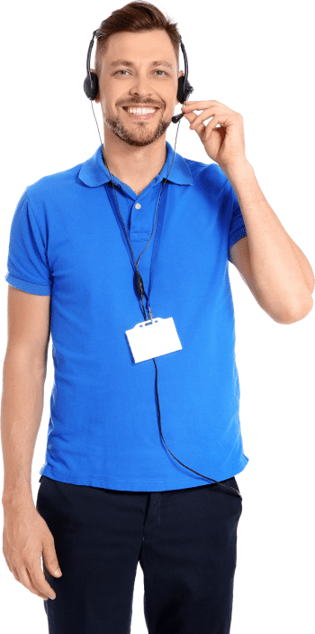 A male employee with a big smile on his face wears a headset and a blue polo shirt, preparing to speak on the phone.